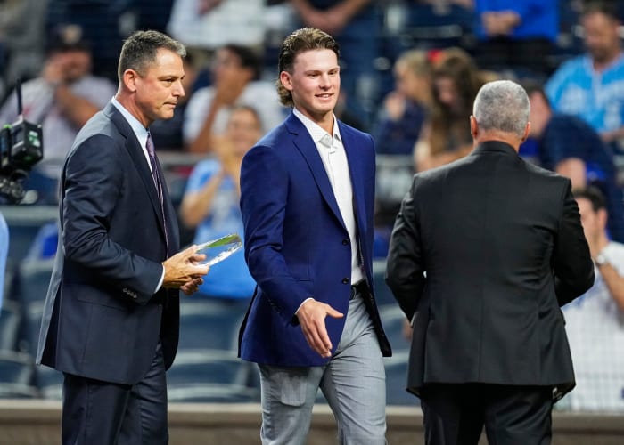 Oct 1, 2021; Kansas City, Missouri, USA; Kansas City Royals minor league shortstop Bobby Witt Jr. receives the Royals Minor League Hitter of the Year Award from general manager J.J. Picollo and president Dayton Moore before the game against the Minnesota Twins at Kauffman Stadium. Mandatory Credit: Jay Biggerstaff-USA TODAY Sports
